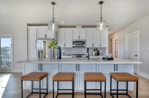 a view of a kitchen and dining table chairs in a kitchen