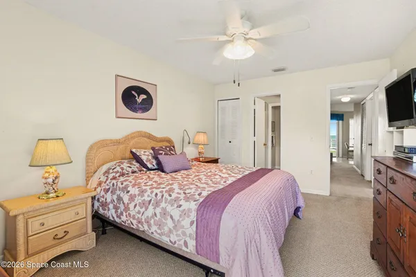 a bedroom with a bed and a tv
