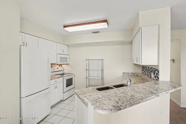 a kitchen with a sink stove and refrigerator