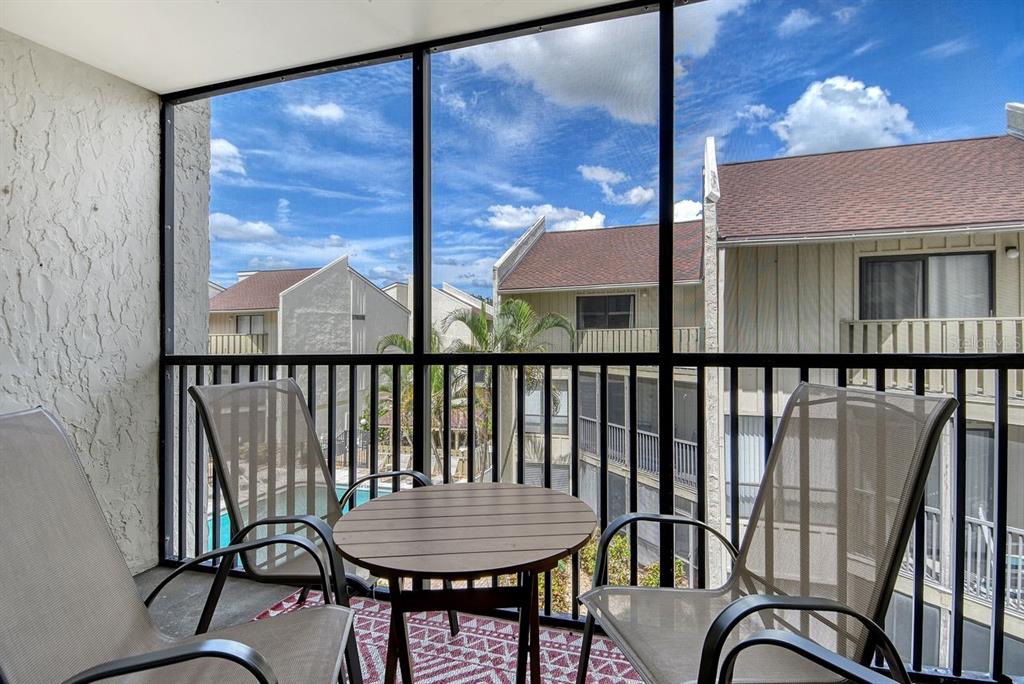 6157 Midnight Pass Road, Unit E63 Sarasota, FL 34242 - Photo 11 of 61 a balcony view with a seating space