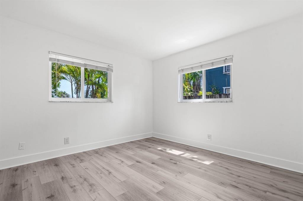 45 Northeast 24th Street, Unit B Wilton Manors, FL 33305 - Photo 13 of 19 a view of empty room with wooden floor and fan