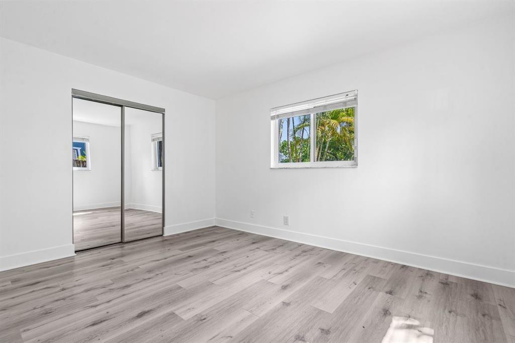 45 Northeast 24th Street, Unit B Wilton Manors, FL 33305 - Photo 14 of 19 an empty room with wooden floor and window