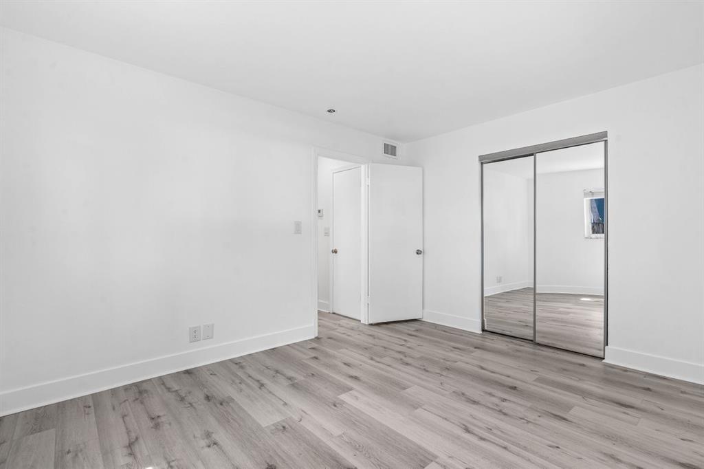 45 Northeast 24th Street, Unit B Wilton Manors, FL 33305 - Photo 16 of 19 a view of an empty room with wooden floor