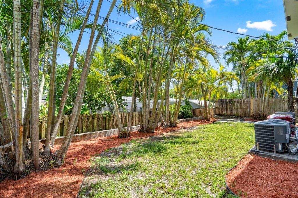 45 Northeast 24th Street, Unit B Wilton Manors, FL 33305 - Photo 19 of 19 a view of backyard with table and chairs and a barbeque