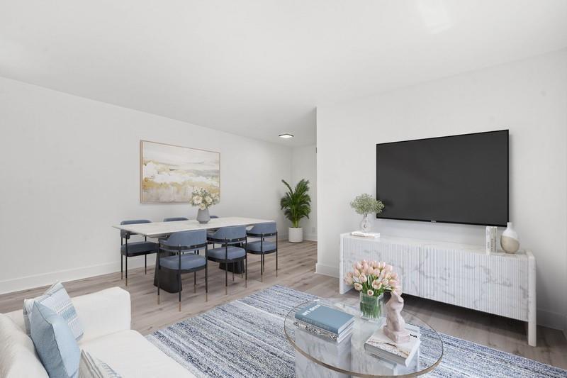 45 Northeast 24th Street, Unit B Wilton Manors, FL 33305 - Photo 3 of 19 a living room with furniture and a flat screen tv