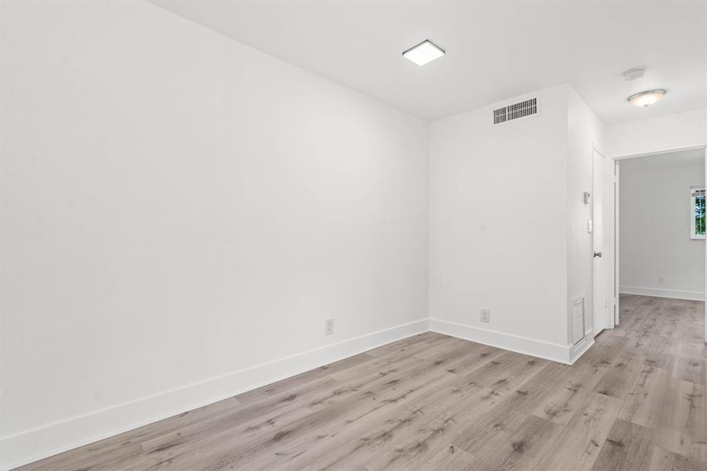 45 Northeast 24th Street, Unit B Wilton Manors, FL 33305 - Photo 8 of 19 a view of a room with wooden floor