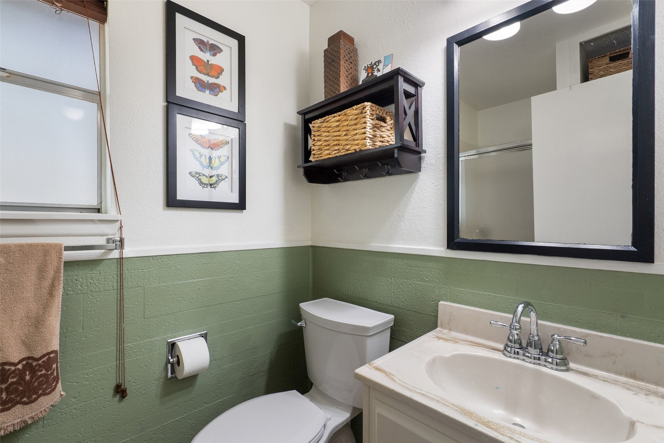141 Perry Lane Kingsland, TX 78639 - Photo 34 of 40 A well-lit bathroom showcases a vanity with a pristine sink and a stylish framed mirror.