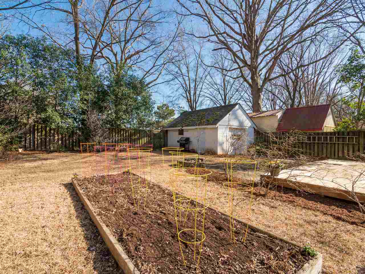 1800 Bennett Street Raleigh, NC 27604 - Photo 16 of 24 Deep shot of the backyard from the house showing the workshop/garage on the right, a raised garden bed in foreground, deck to the right... Backyard