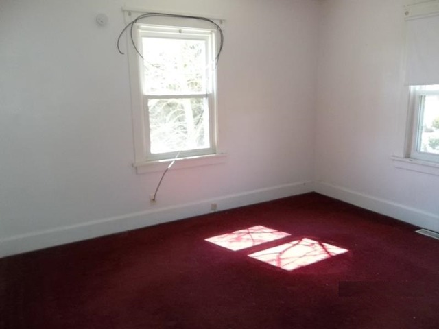 1403 Ogilby Road Rockford, IL 61102 - Photo 3 of 7 an empty room with a window