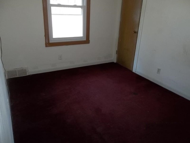 1403 Ogilby Road Rockford, IL 61102 - Photo 4 of 7 an empty room with a window