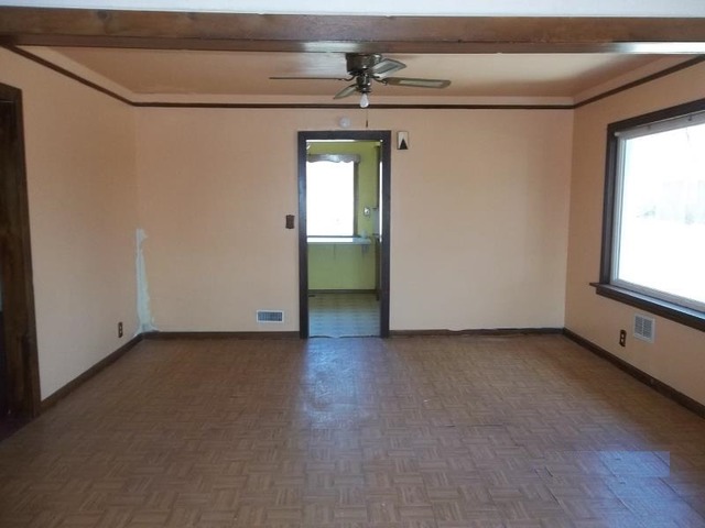 1403 Ogilby Road Rockford, IL 61102 - Photo 5 of 7 a view of a livingroom with wooden floor and a window