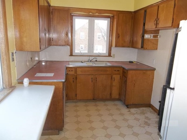 1403 Ogilby Road Rockford, IL 61102 - Photo 6 of 7 a kitchen with a sink a stove and cabinets