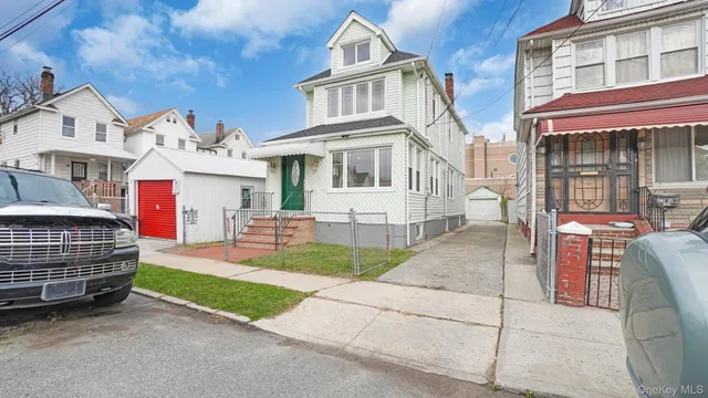 a front view of a house with a garden and trees