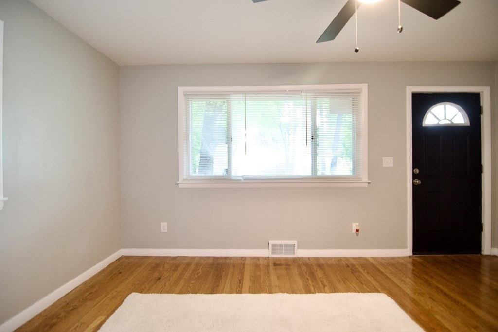 11 Aberdeen Road Springfield, MA 01109 - Photo 4 of 42 wooden floor in an empty room with a window