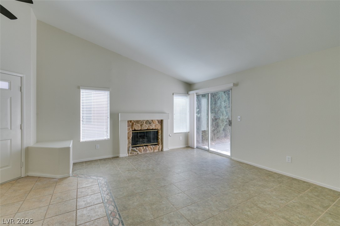 307 Cavalla Street Henderson, NV 89074 - Photo 8 of 44 A stone-clad fireplace and tiled flooring provide character in this naturally illuminated living space.