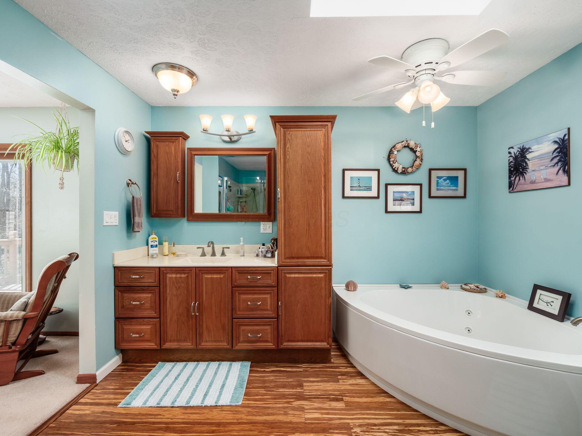 12741 Goodman Road Ashville, OH 43103 - Photo 23 of 61 The primary bathroom has both a walk-in glass-walled shower and an immense jetted soaking tub!