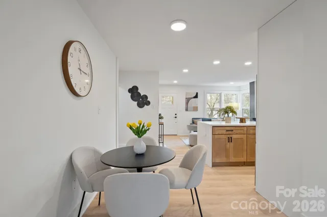 a dining room with furniture and a mirror