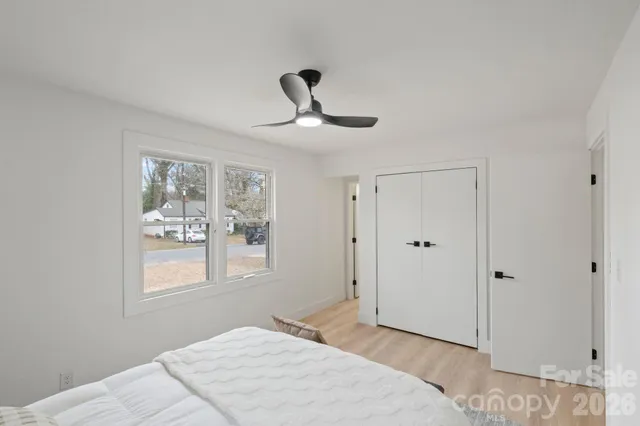 a bedroom with a large bed and a window