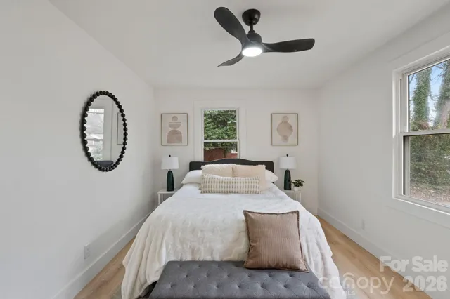 a bedroom with a large bed and a window