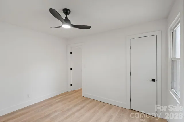 a view of a room with a ceiling fan and a window
