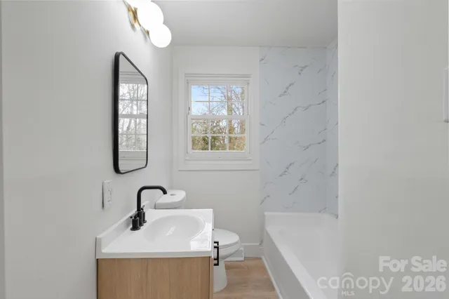 a bathroom with a sink a toilet and bathtub