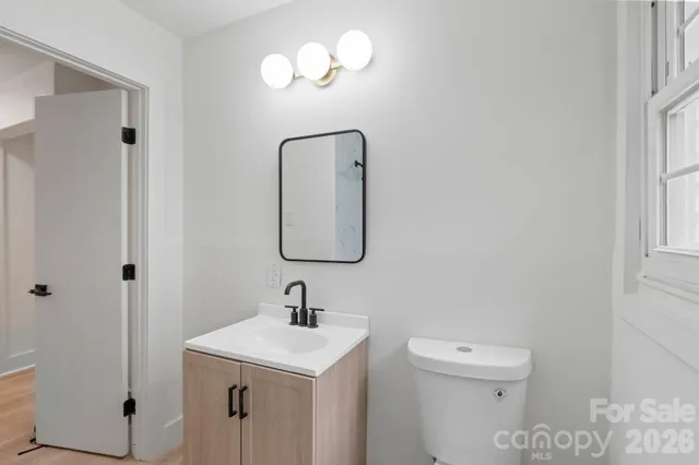 a bathroom with a toilet sink and mirror