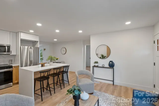 a dining room with furniture and a wooden floor