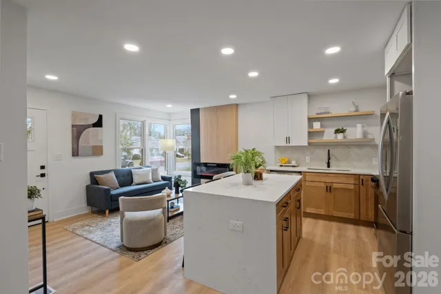 a kitchen with sink a refrigerator and couches