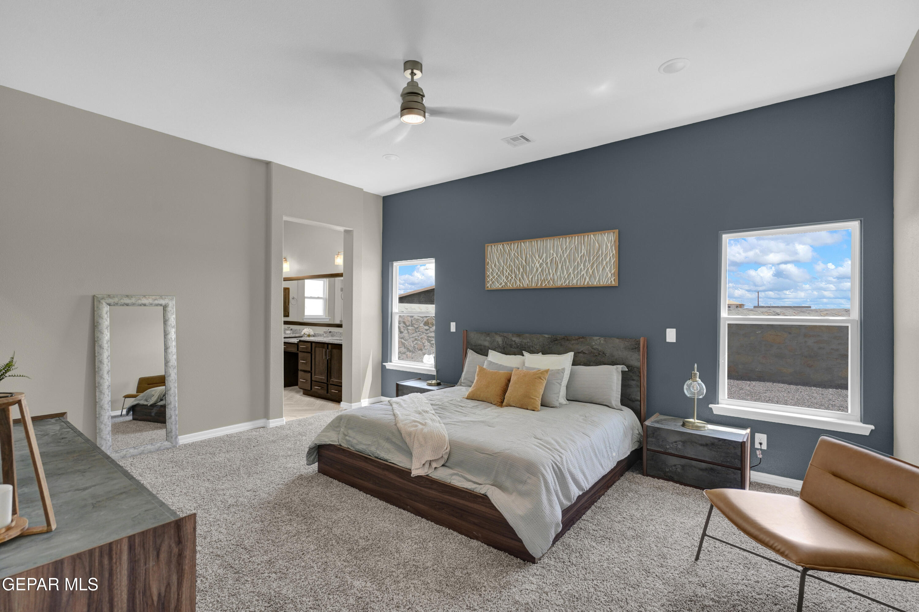 6958 Levee Circle El Paso, TX 79932 - Photo 24 of 55 a bedroom with a large bed a chandelier and windows