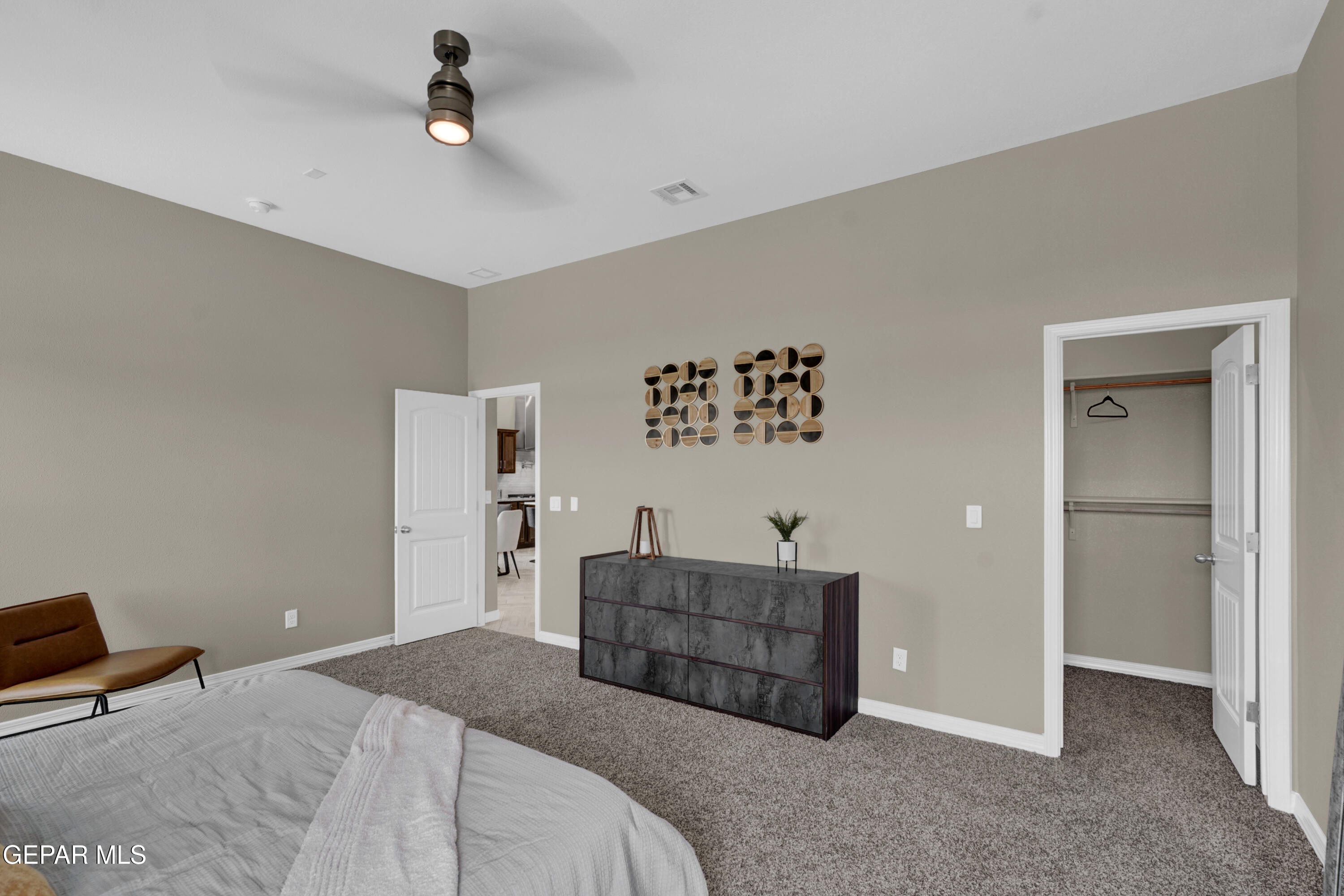 6958 Levee Circle El Paso, TX 79932 - Photo 27 of 55 a spacious bedroom with a bed and cabinet