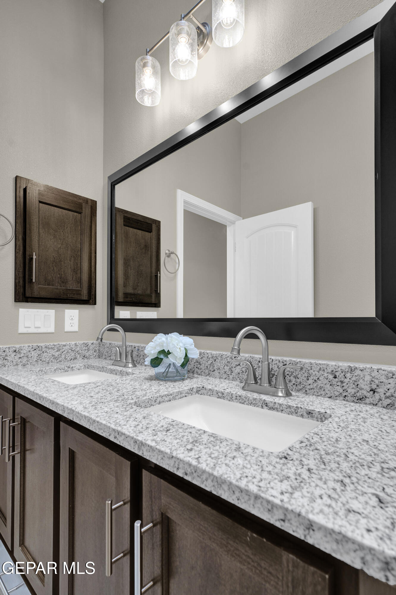 6958 Levee Circle El Paso, TX 79932 - Photo 44 of 55 a bathroom with a granite countertop sink and a mirror