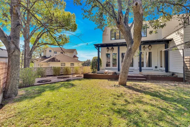a view of a house with swimming pool and sitting area