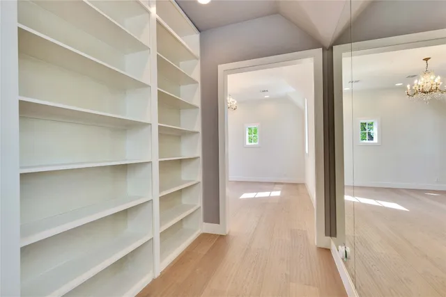 a view of a room with wooden floor and windows