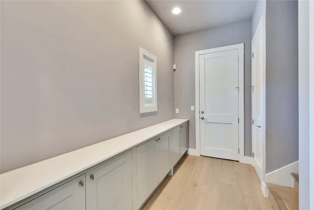 a view of an empty room with window and closet area
