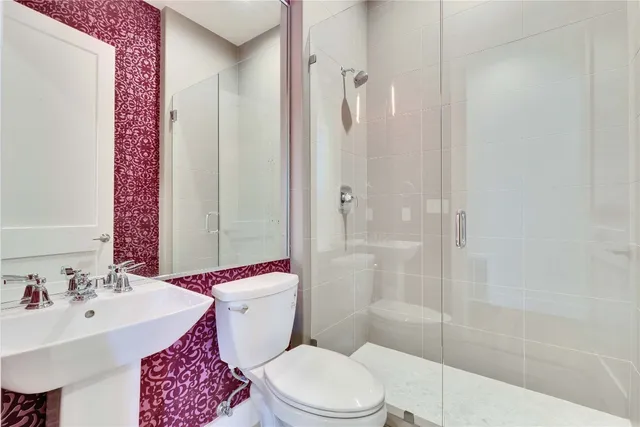 a bathroom with a sink toilet and shower