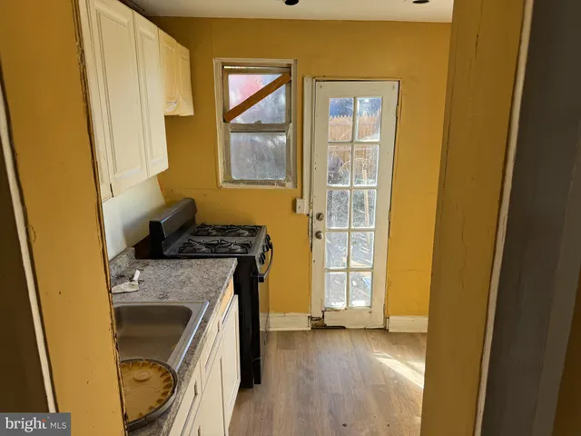 a kitchen with a sink a stove and a window
