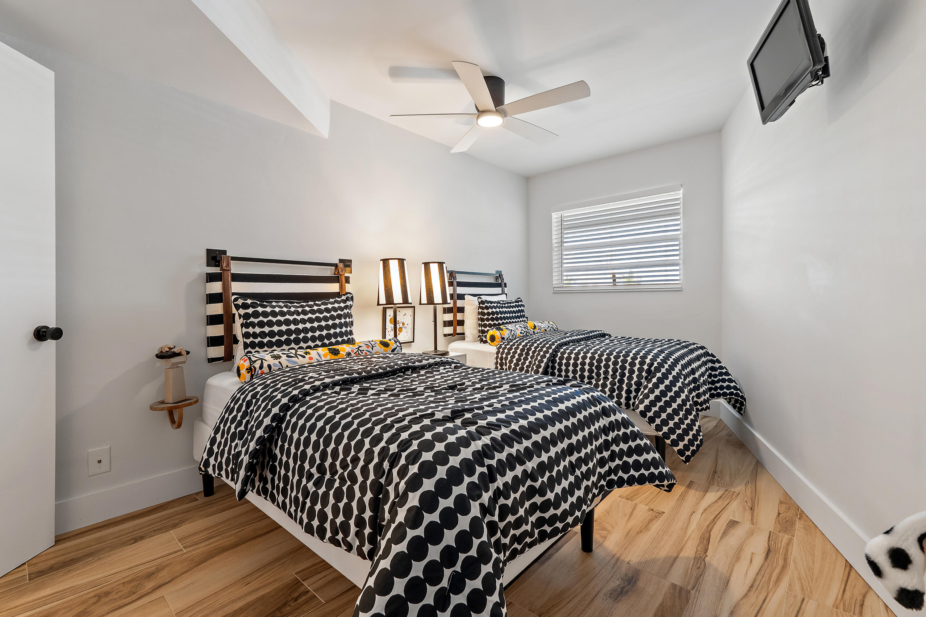 50 Celestial Way, Unit 310 Juno Beach, FL 33408 - Photo 24 of 33 a bedroom with a bed and wooden floor