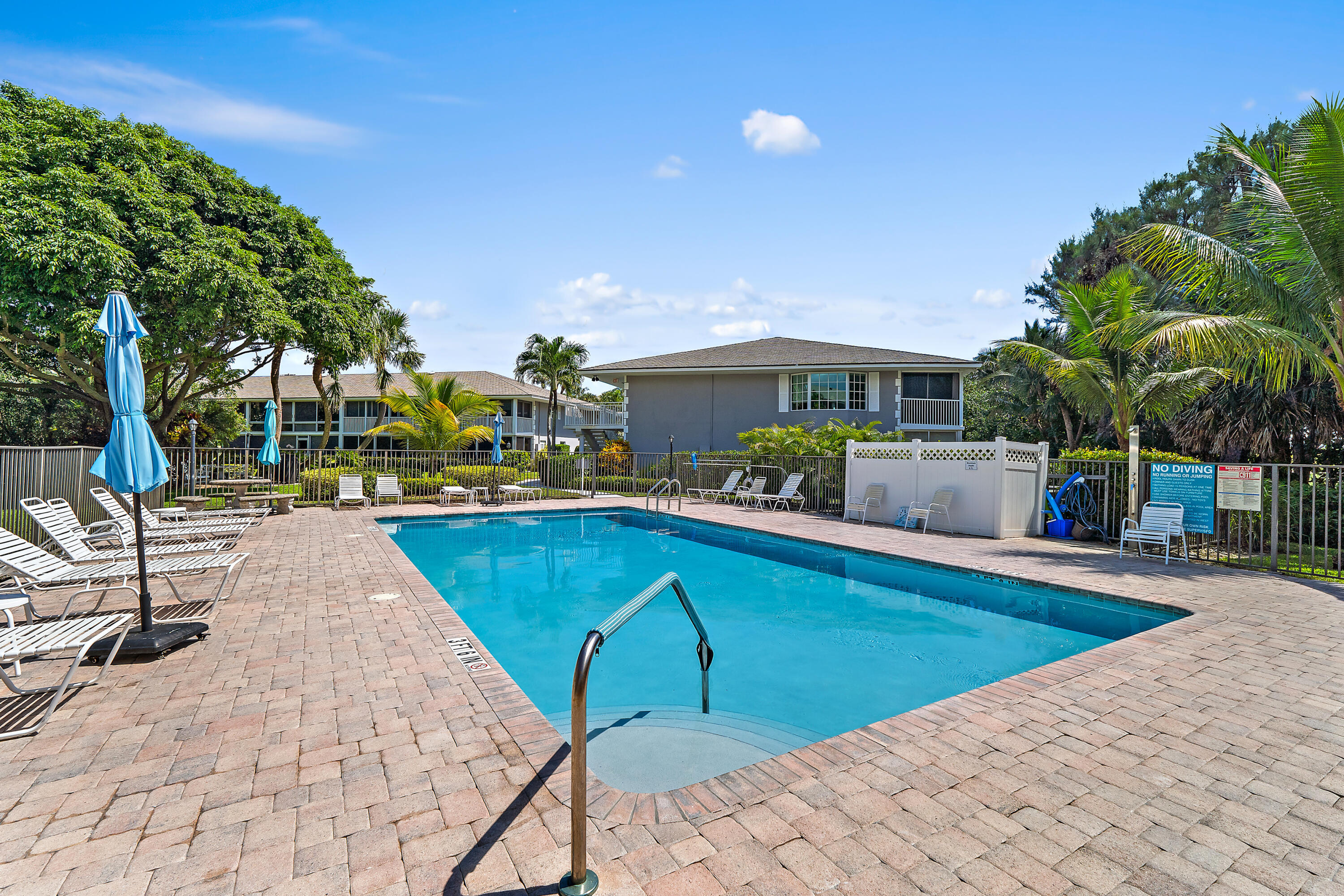 50 Celestial Way, Unit 310 Juno Beach, FL 33408 - Photo 27 of 33 a view of a swimming pool with a lounge chairs