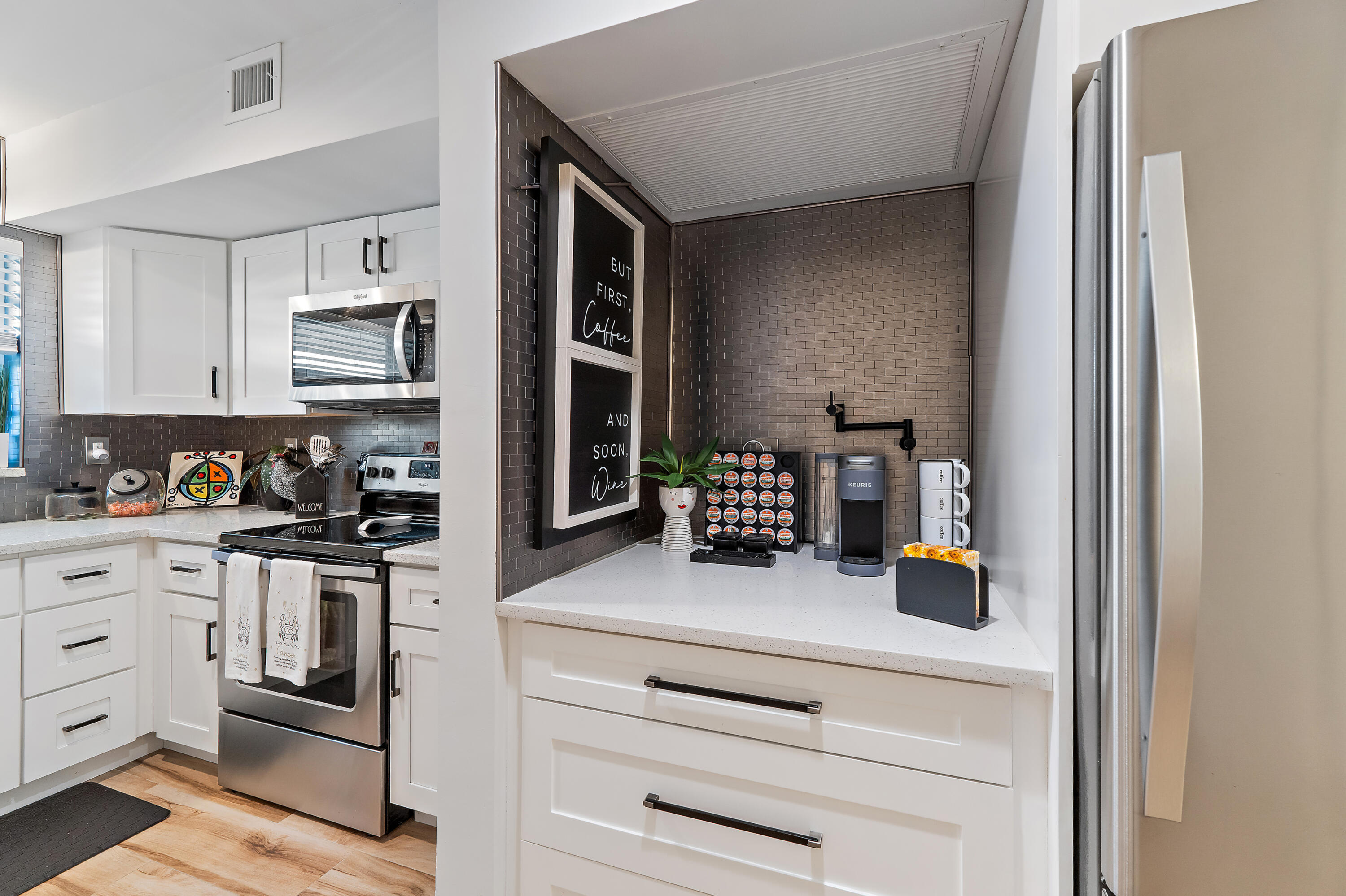 50 Celestial Way, Unit 310 Juno Beach, FL 33408 - Photo 4 of 33 a kitchen with stainless steel appliances granite countertop a stove and a refrigerator