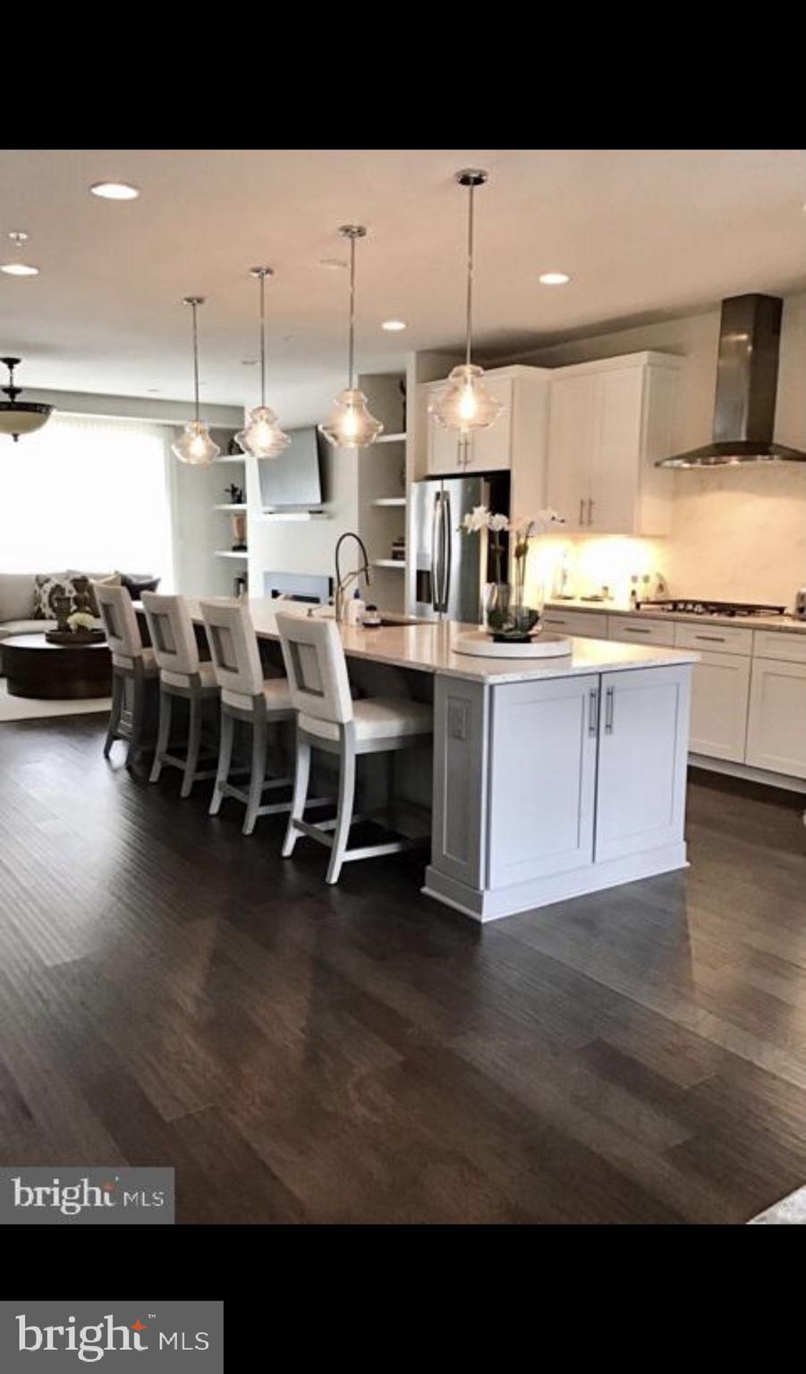 22283 Philanthropic Drive Ashburn, VA 20148 - Photo 5 of 17 a open kitchen with stainless steel appliances kitchen island granite countertop a sink and cabinets