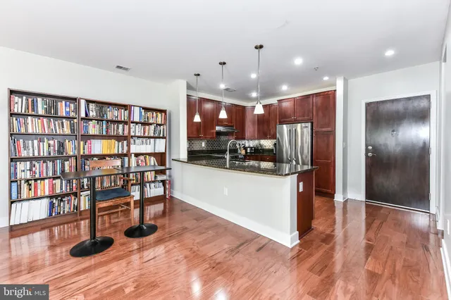 a view of kitchen with furniture and wooden floor