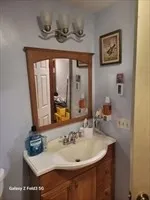 a bathroom with a sink and a mirror