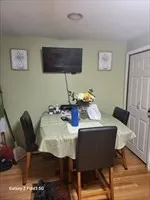 a dining room with furniture and wooden floor