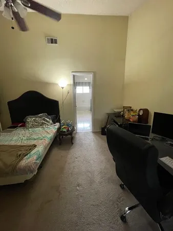 a bedroom with a bed and a desk