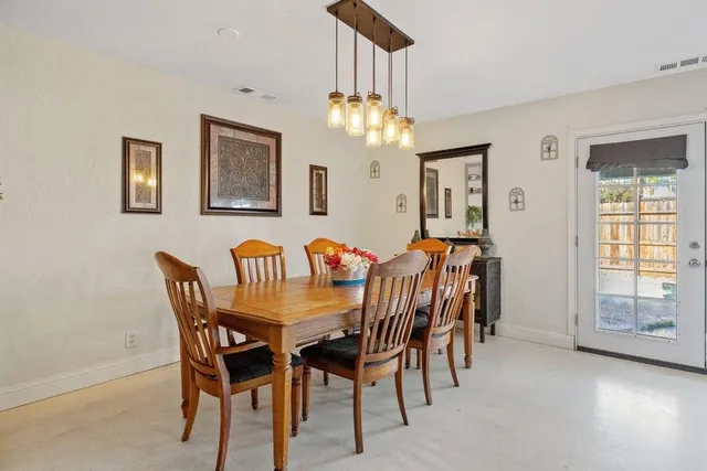 a view of a dining room with furniture and chandelier
