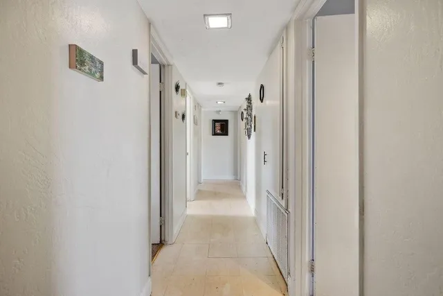 a view of a hallway with a white walls