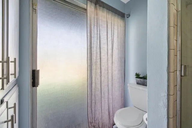 a white toilet sitting next to a bathroom sink