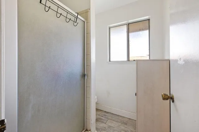 a bathroom with a shower and a window