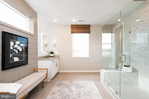 a spacious bathroom with a double vanity sink and a bathtub