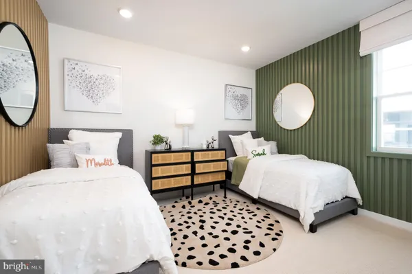 a bedroom with a bed mirror and window